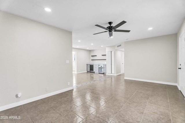 unfurnished living room featuring a ceiling fan, visible vents, and baseboards