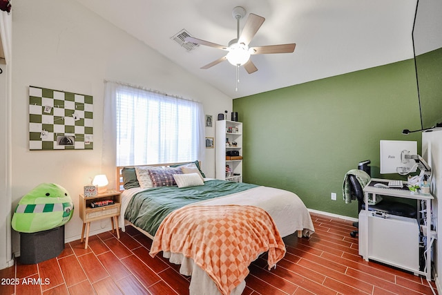 bedroom featuring baseboards, vaulted ceiling, a ceiling fan, and wood finish floors