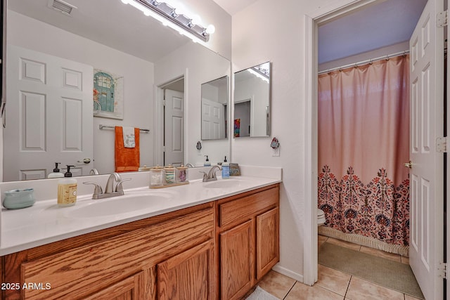 full bathroom featuring toilet, a sink, visible vents, and tile patterned floors