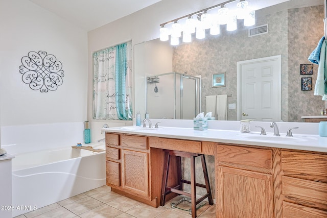 full bathroom featuring tile patterned flooring, a sink, visible vents, and a shower stall