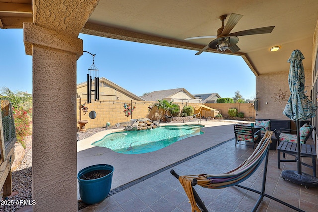 view of swimming pool with a fenced in pool, a fenced backyard, a patio, and a ceiling fan