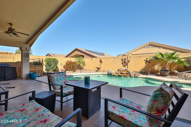 view of swimming pool with a fenced backyard, a grill, a ceiling fan, a fenced in pool, and a patio area