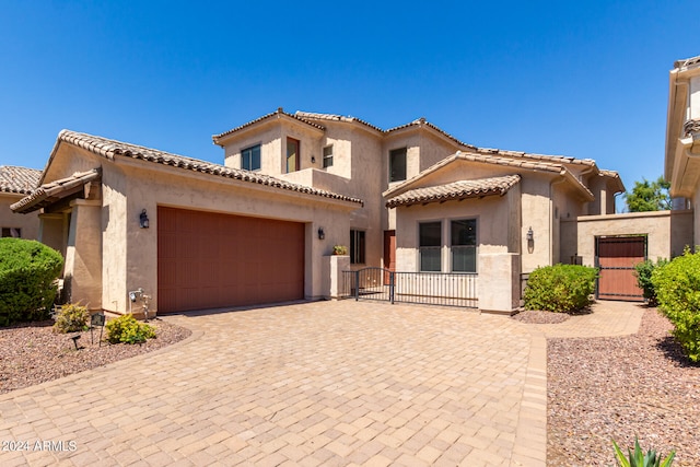 mediterranean / spanish home with a garage