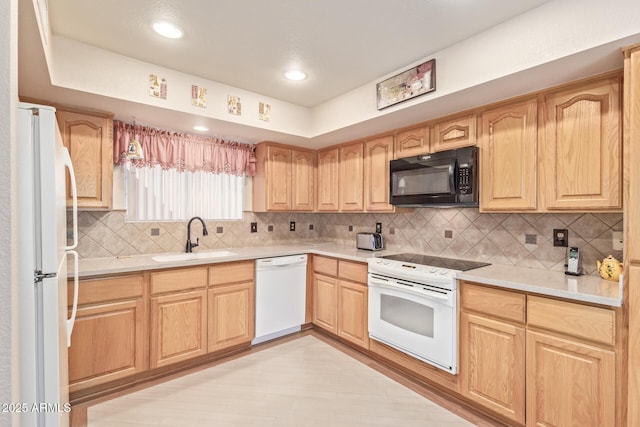 kitchen featuring tasteful backsplash, sink, white appliances, and light wood-type flooring