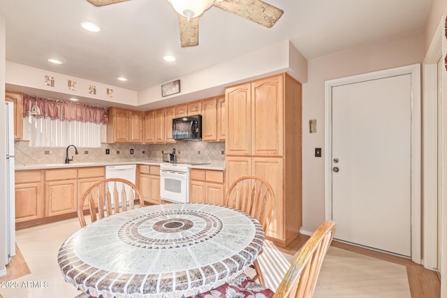 kitchen with white appliances, sink, decorative backsplash, and light brown cabinets