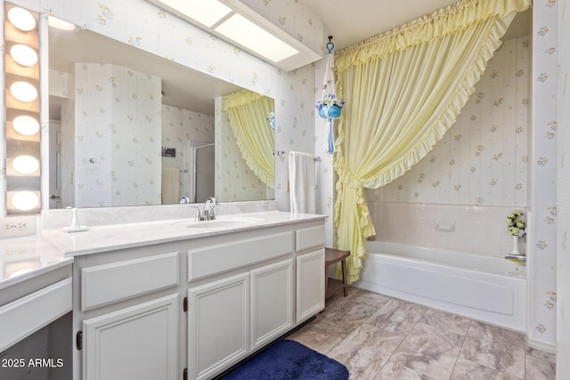 bathroom with tiled shower / bath, vanity, and a skylight