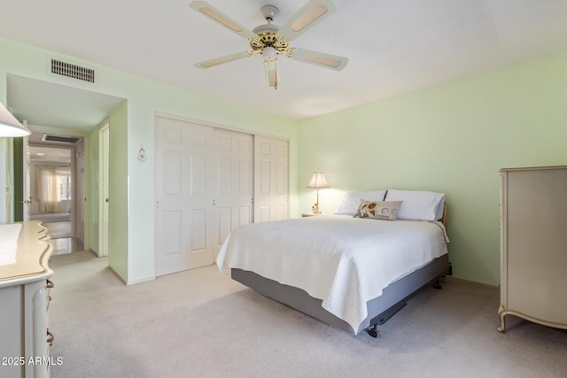 carpeted bedroom featuring ceiling fan and a closet