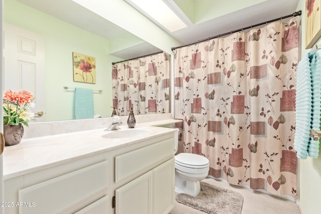 bathroom with vanity, toilet, a skylight, and a shower with shower curtain