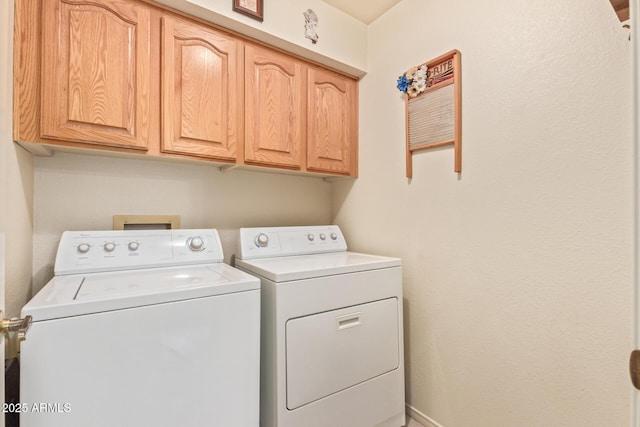 laundry room featuring cabinets and washing machine and dryer