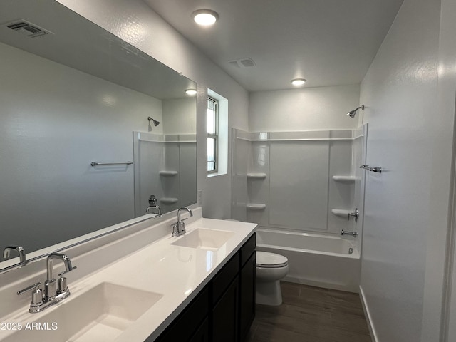 bathroom with visible vents, a sink, toilet, and tub / shower combination