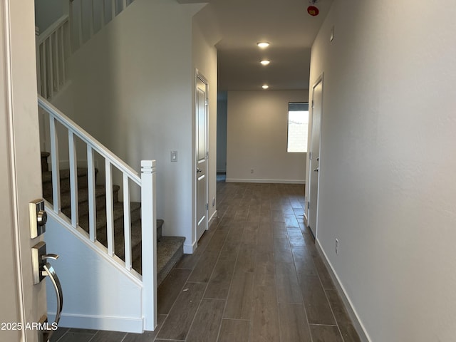 corridor featuring dark wood-style floors, recessed lighting, stairway, and baseboards