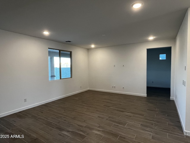 unfurnished room with dark wood-type flooring, recessed lighting, and baseboards