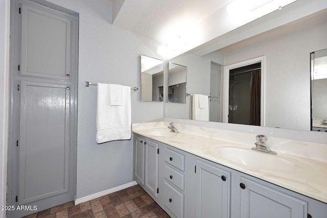 205 N 74th St Unit 248, Mesa, AZ 85207 - bathroom with baseboards, double vanity, and brick patterned floors