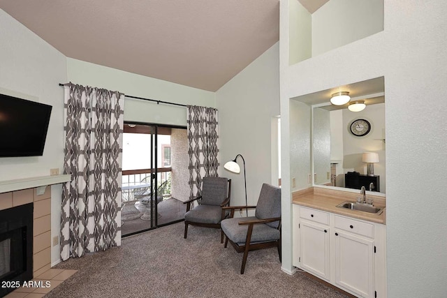 205 N 74th St Unit 248, Mesa, AZ 85207 - sitting room with lofted ceiling, carpet floors, a tile fireplace, and bar area
