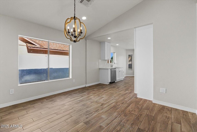 1736 E Bluefield Ave, Phoenix, AZ 85022 - unfurnished living room with wood finished floors, a chandelier, lofted ceiling, and recessed lighting