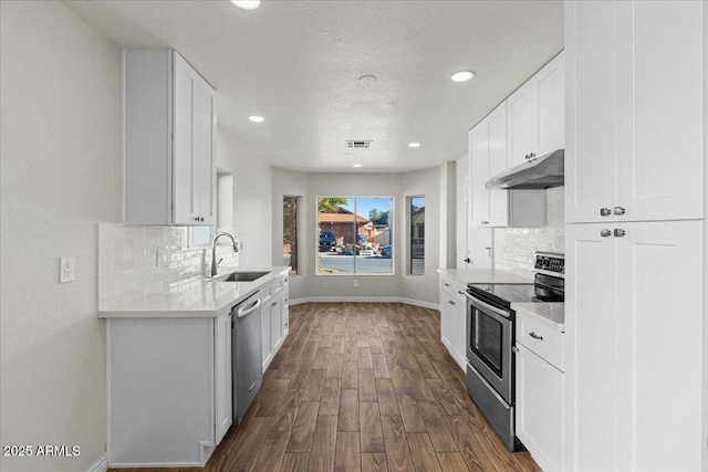 1736 E Bluefield Ave, Phoenix, AZ 85022 - kitchen featuring appliances with stainless steel finishes, under cabinet range hood, backsplash, dark wood-type flooring, and recessed lighting