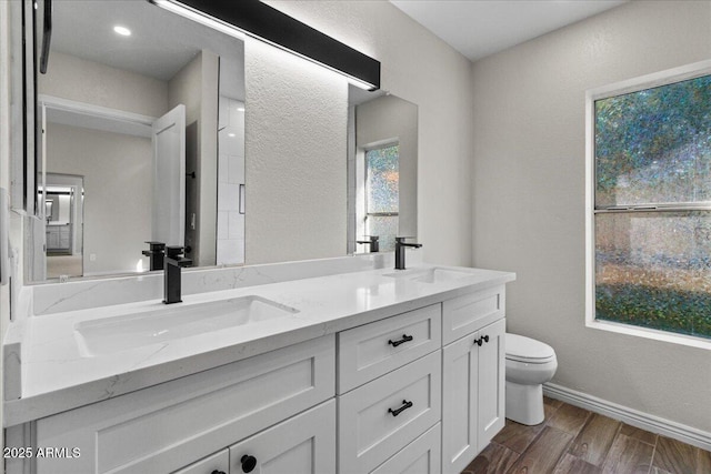 1736 E Bluefield Ave, Phoenix, AZ 85022 - bathroom featuring double vanity, wood finished floors, and a textured wall