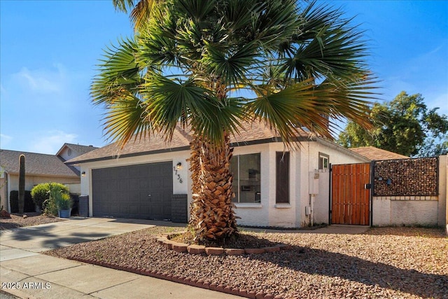1736 E Bluefield Ave, Phoenix, AZ 85022 - view of front facade with a gate, an attached garage, concrete driveway, and stucco siding