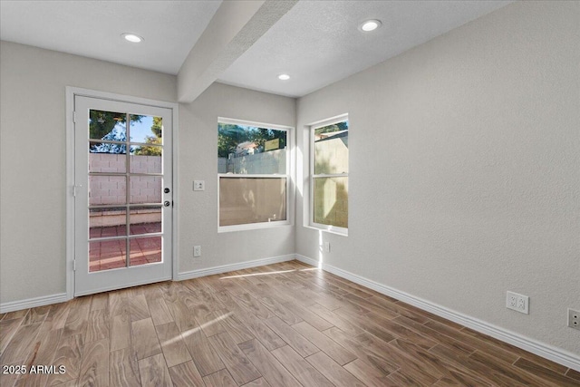 1736 E Bluefield Ave, Phoenix, AZ 85022 - spare room with wood finished floors, recessed lighting, beamed ceiling, and a textured wall