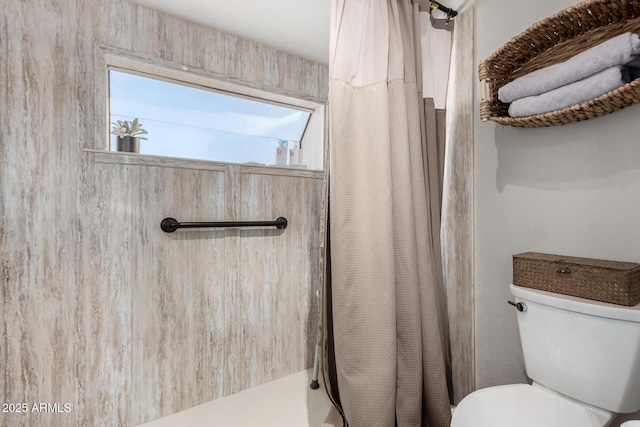 bathroom with toilet and walk in shower