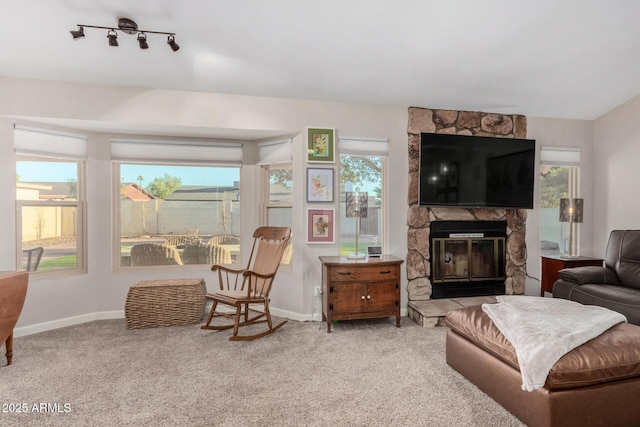 carpeted living room featuring a wealth of natural light and a fireplace