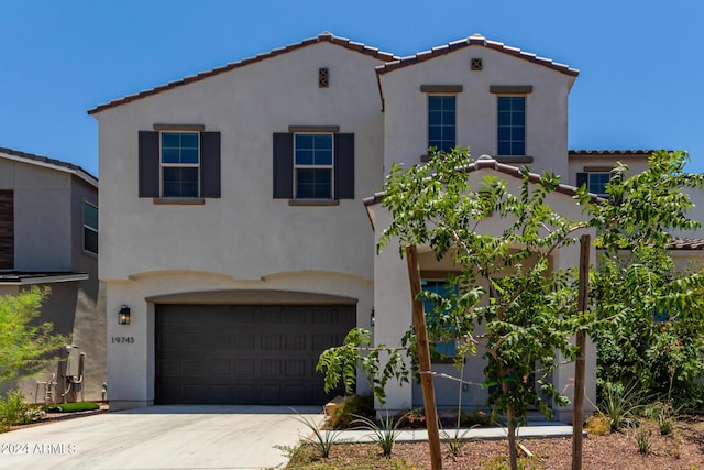 mediterranean / spanish house featuring a garage