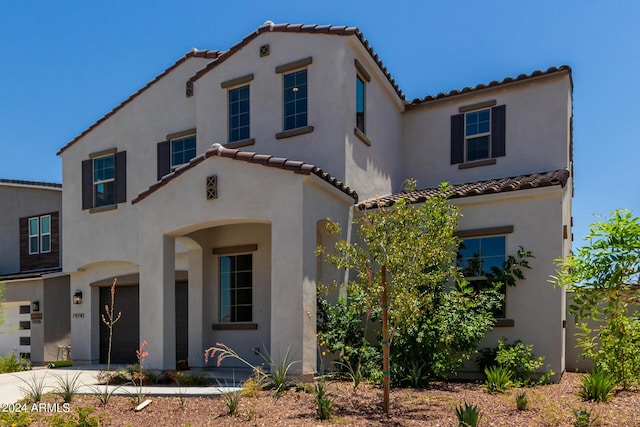 mediterranean / spanish home with a garage