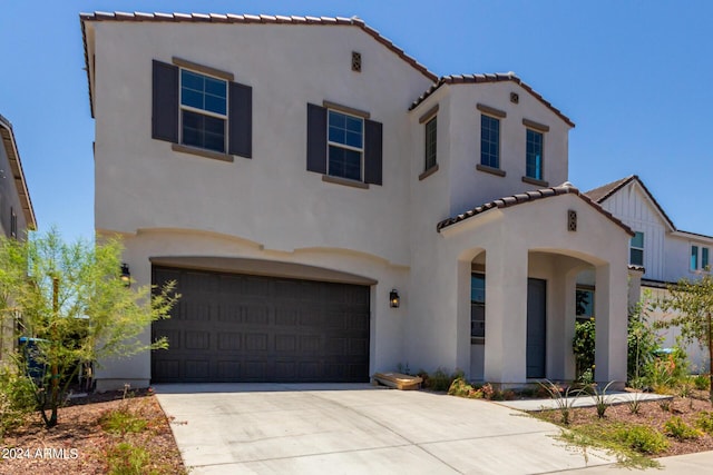 mediterranean / spanish house with a garage