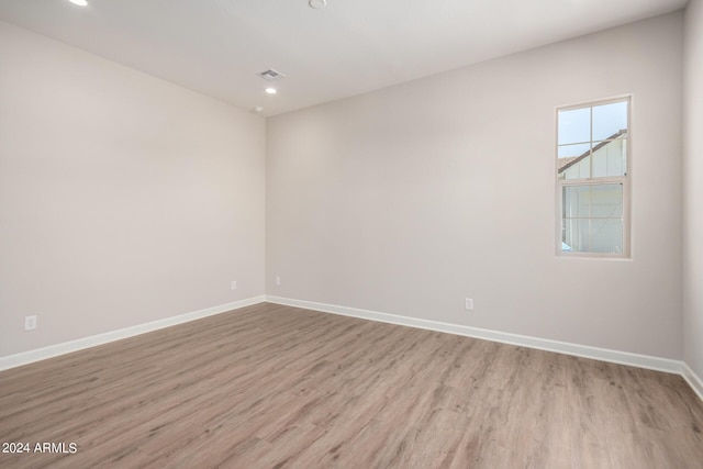 unfurnished room with light wood-type flooring