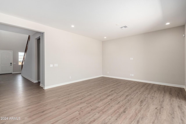 spare room featuring wood-type flooring