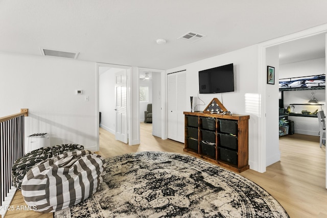 bedroom with light hardwood / wood-style floors and a closet