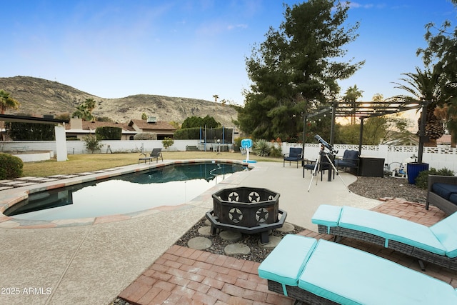 view of swimming pool featuring a trampoline, a mountain view, a pergola, and a patio area