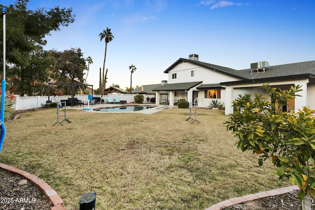 view of yard featuring a fenced in pool and cooling unit