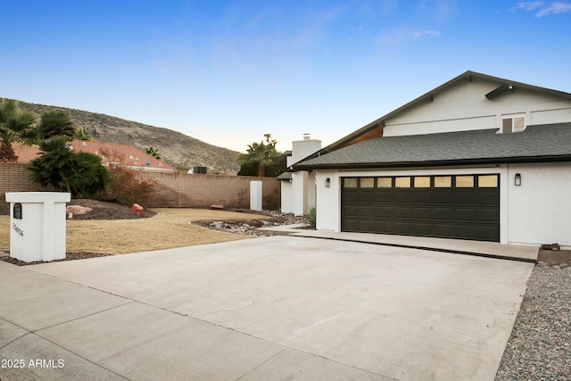 exterior space with a mountain view and a garage