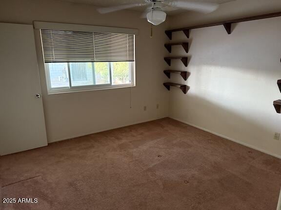 empty room with a ceiling fan and light colored carpet