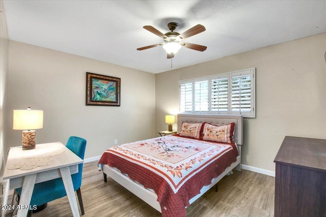 7502 E Carefree Dr Unit 106, Carefree, AZ 85377 - bedroom featuring a ceiling fan, wood finished floors, and baseboards