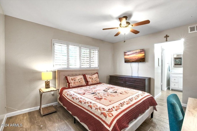 bedroom featuring wood-type flooring, ensuite bath, and ceiling fan