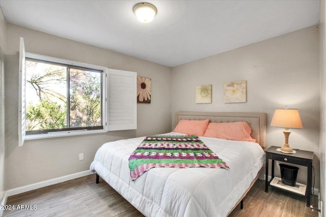 7502 E Carefree Dr Unit 106, Carefree, AZ 85377 - bedroom with baseboards and wood finished floors