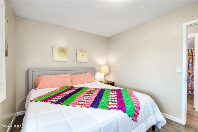 bedroom with hardwood / wood-style floors