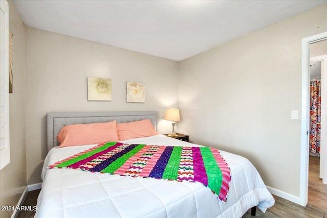 7502 E Carefree Dr Unit 106, Carefree, AZ 85377 - bedroom with baseboards and wood finished floors