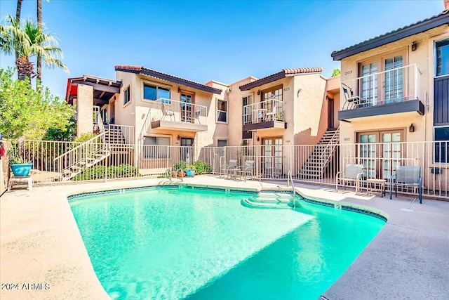 7502 E Carefree Dr Unit 106, Carefree, AZ 85377 - community pool featuring french doors, fence, stairs, and a patio area