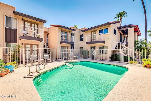 7502 E Carefree Dr Unit 106, Carefree, AZ 85377 - pool with a patio area, french doors, stairs, and fence