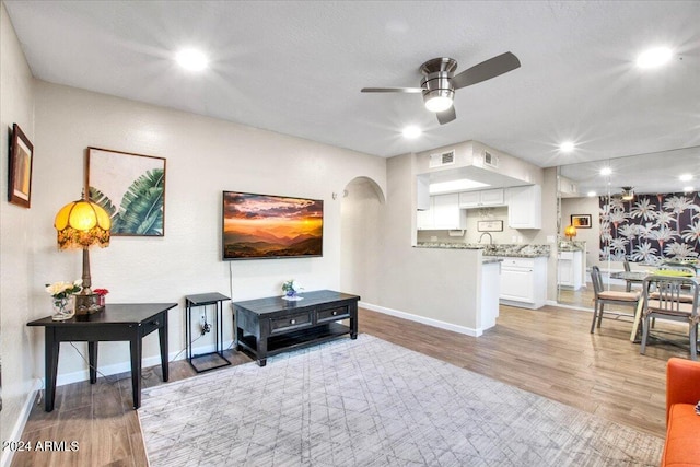 interior space with ceiling fan, light wood-type flooring, and sink