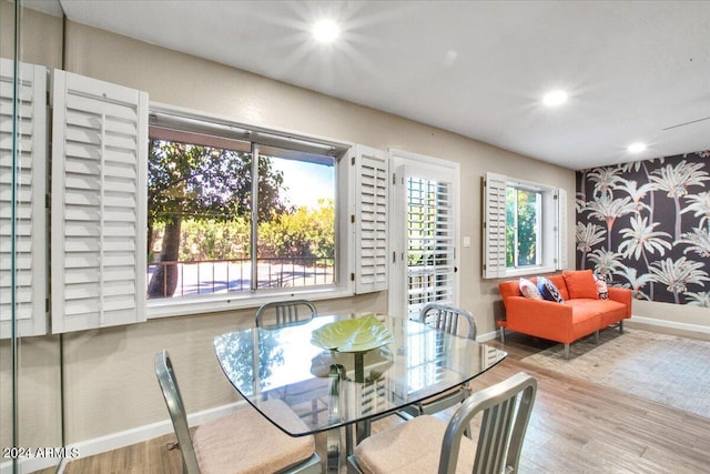 dining area with light hardwood / wood-style flooring and a healthy amount of sunlight