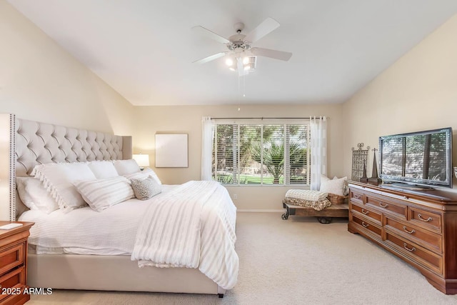 carpeted bedroom with vaulted ceiling, baseboards, and ceiling fan