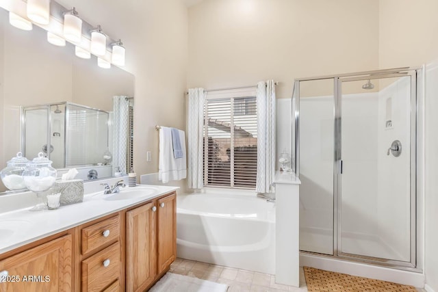 bathroom with a stall shower, a garden tub, vanity, and tile patterned floors