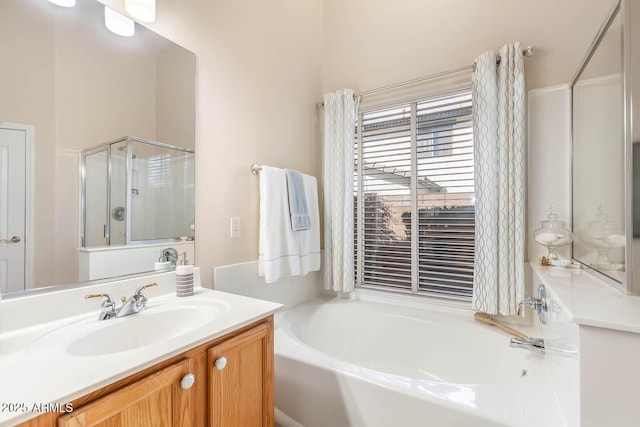 full bathroom with a stall shower, vanity, and a bath