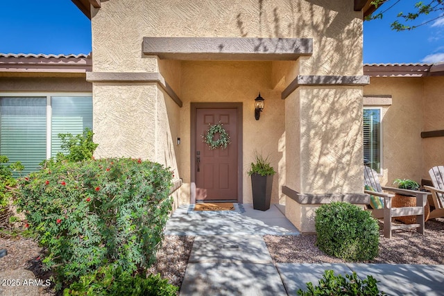 property entrance with stucco siding