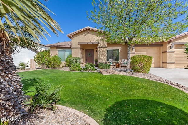 view of front of house featuring a garage, a front yard, a tiled roof, and stucco siding