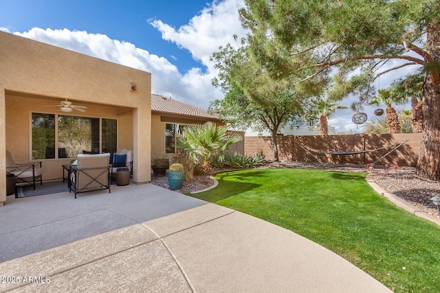 view of yard featuring ceiling fan, a patio area, and fence